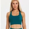 Model wearing fiit pixie sports bra in Forest Green