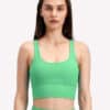 Model wearing fiit pixie sports bra in bright green