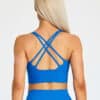 Model wearing fiit pixie sports bra in bright blue